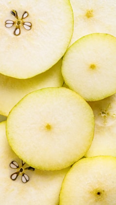 A close-up of juicy apple and pear slices, perfectly packed in a compartmentalized box