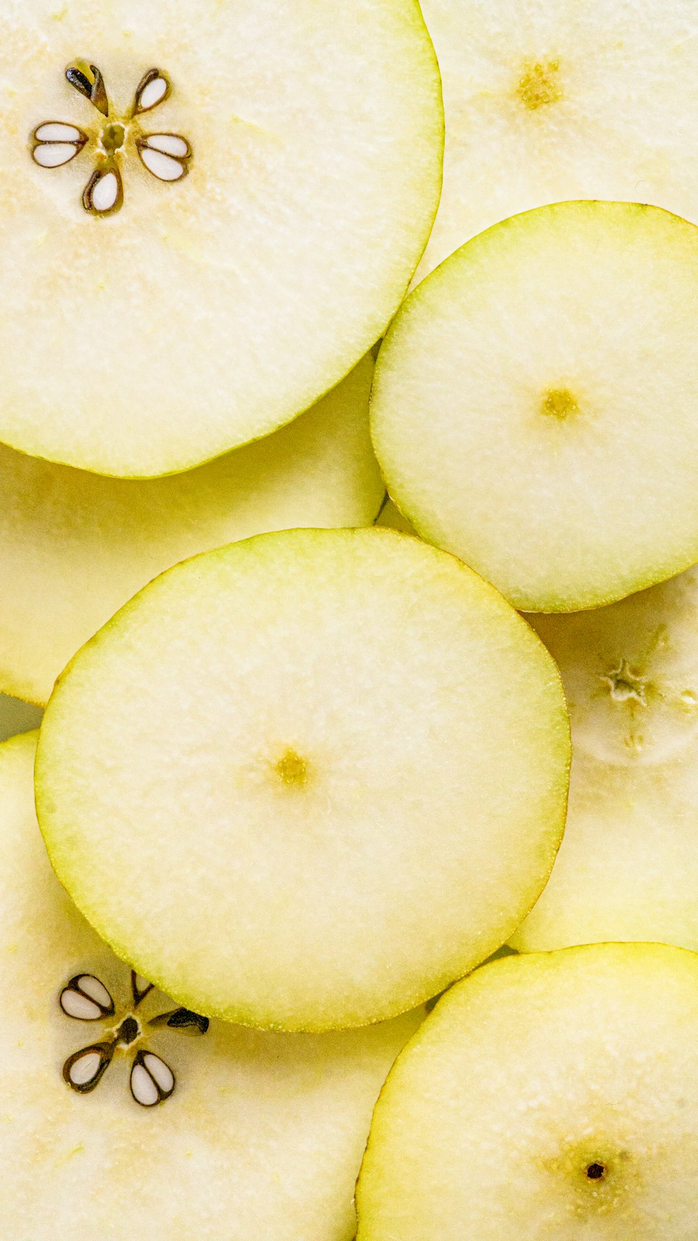 a pile of sliced apples sitting on top of a table