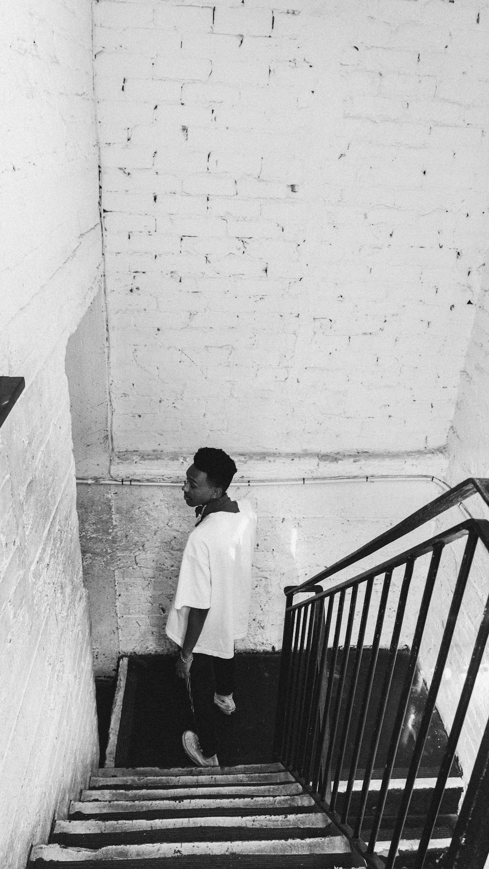 a young boy standing on a set of stairs
