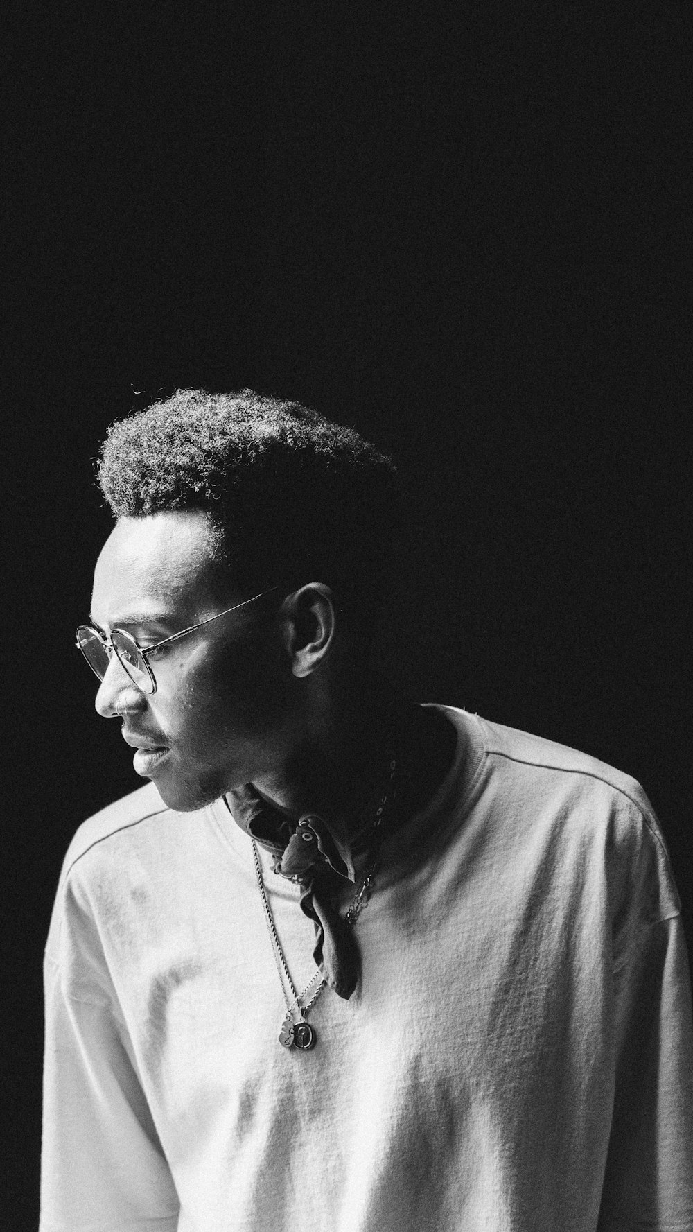 a black and white photo of a man wearing glasses