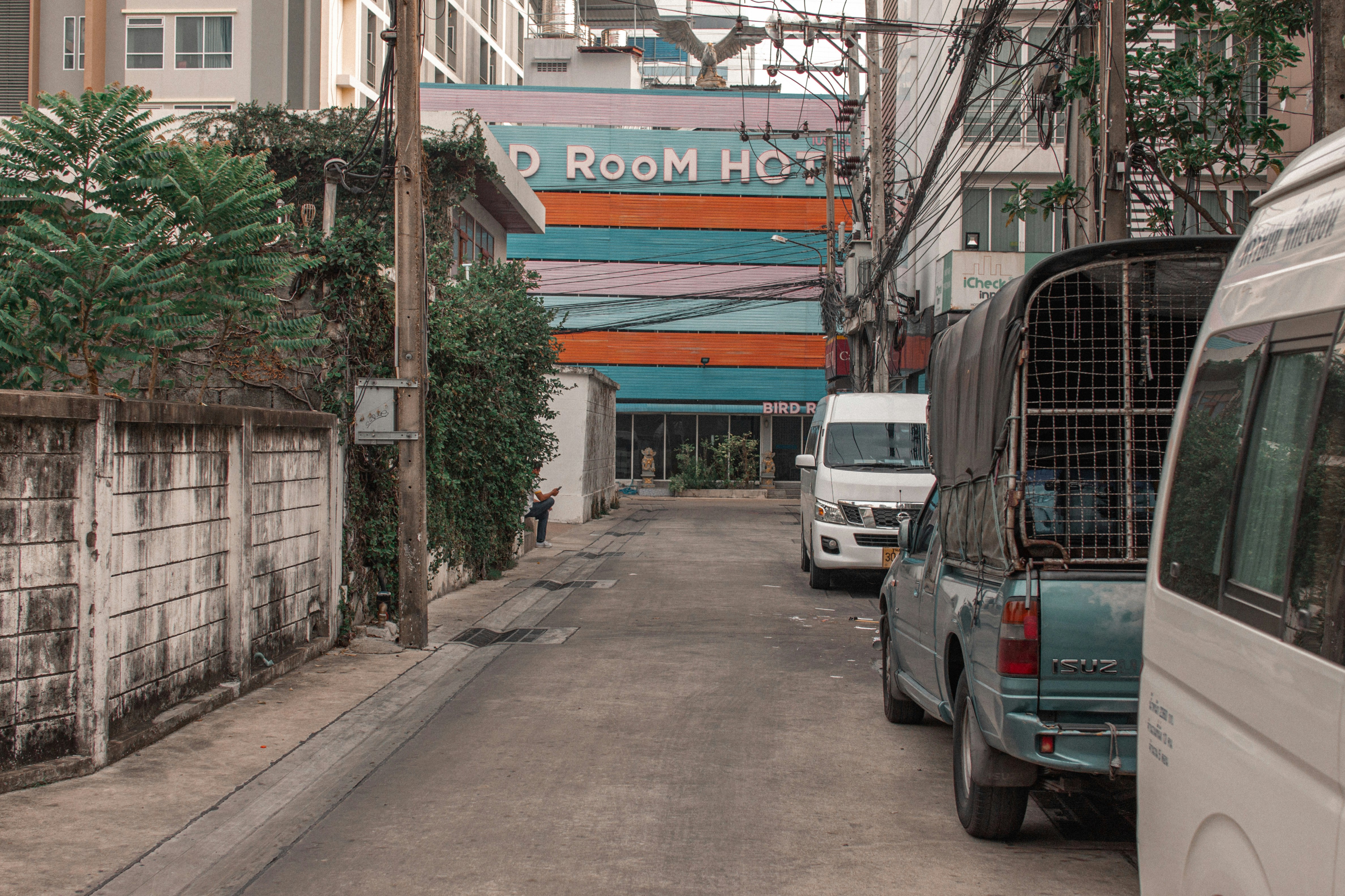 a city street with several vehicles parked on the side of it
