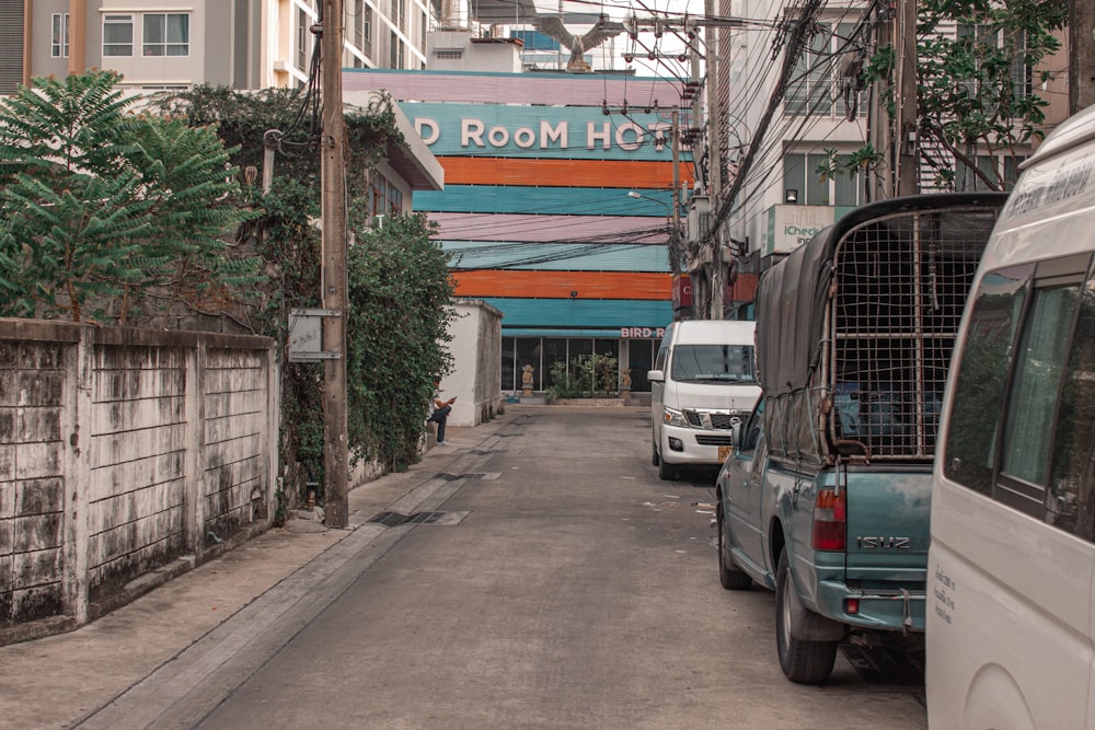 a city street with several vehicles parked on the side of it