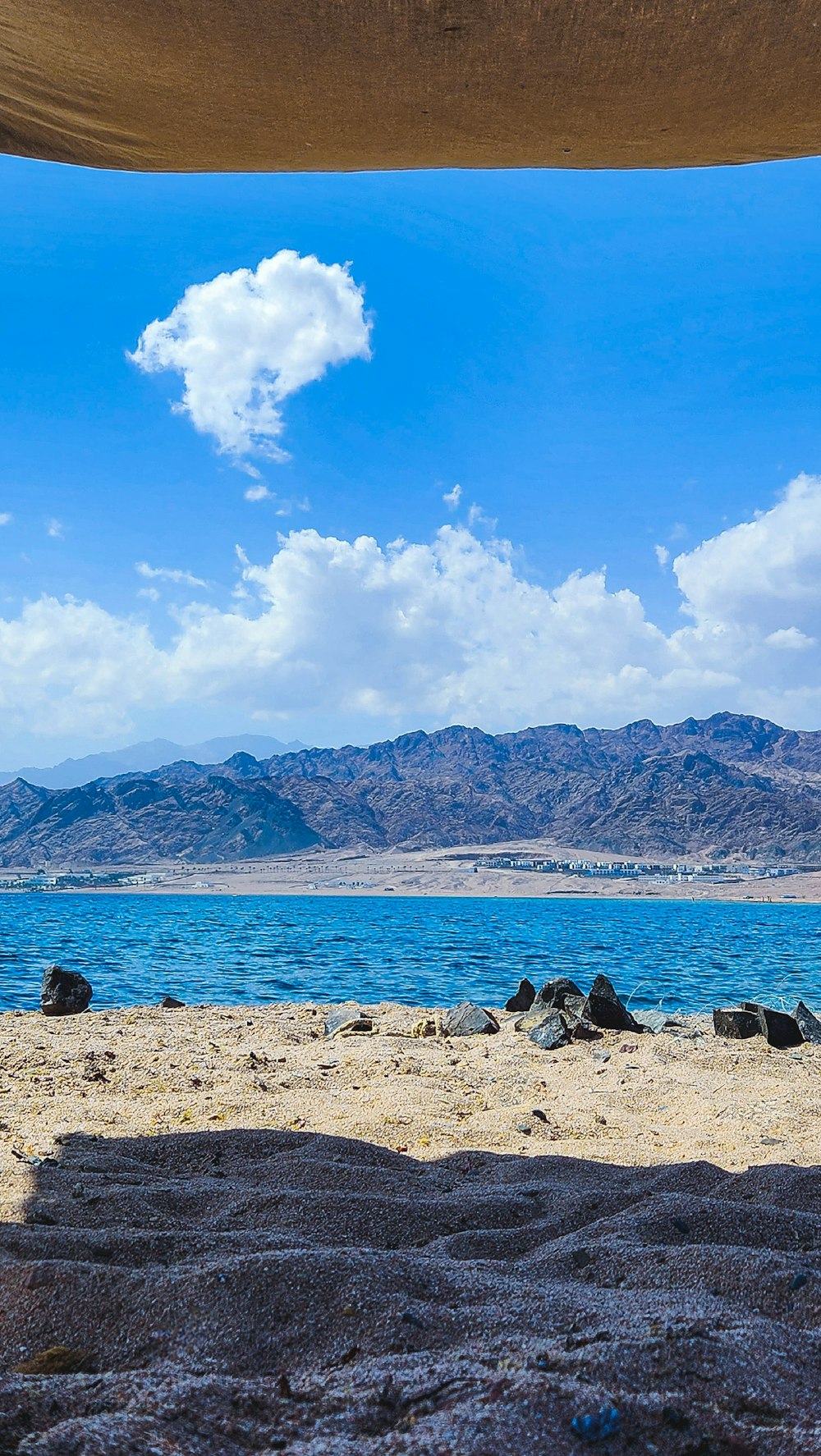 a view of a body of water with mountains in the background