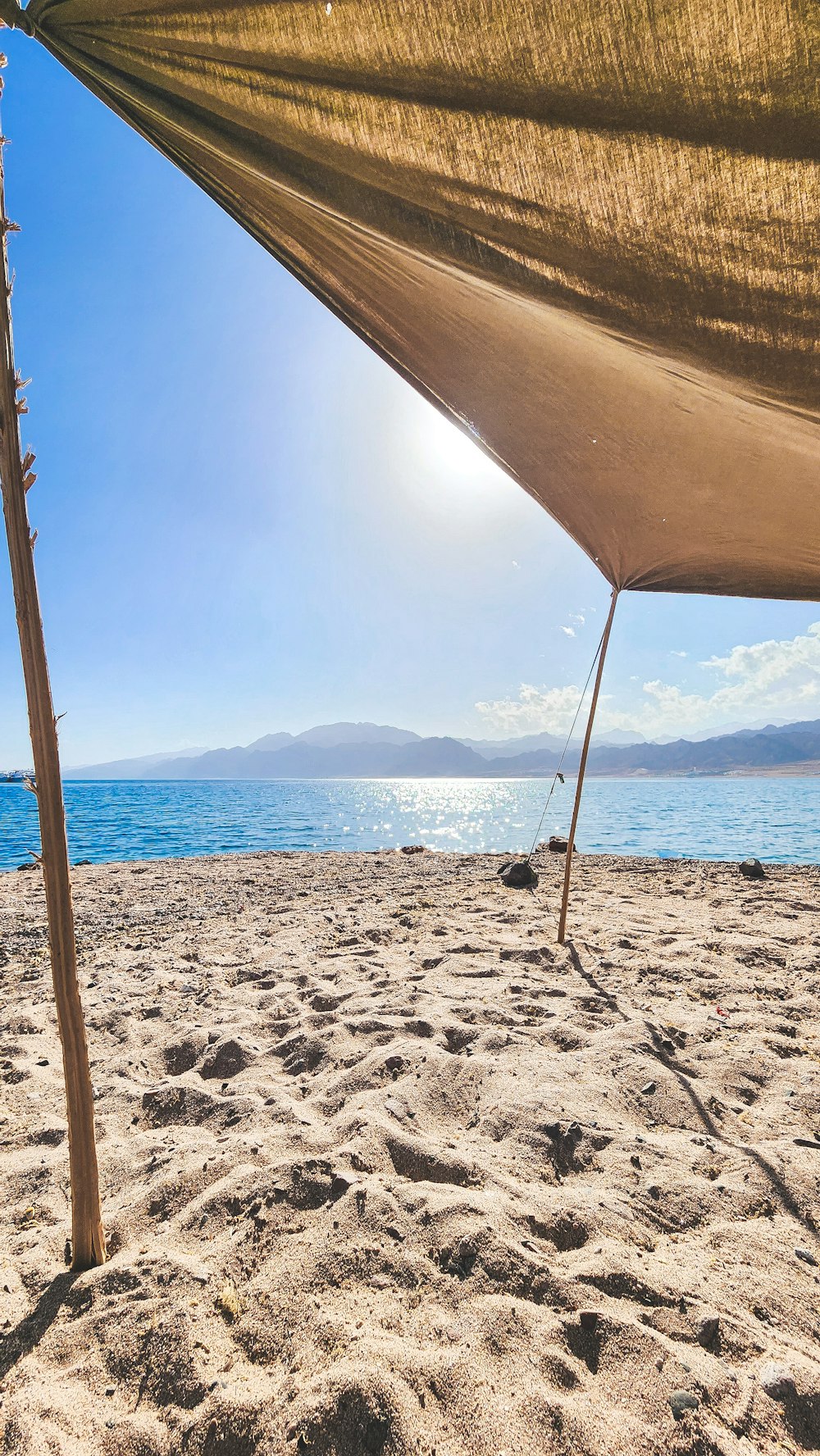 a view of the ocean from a sandy beach