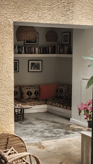 a living room filled with furniture and a plant