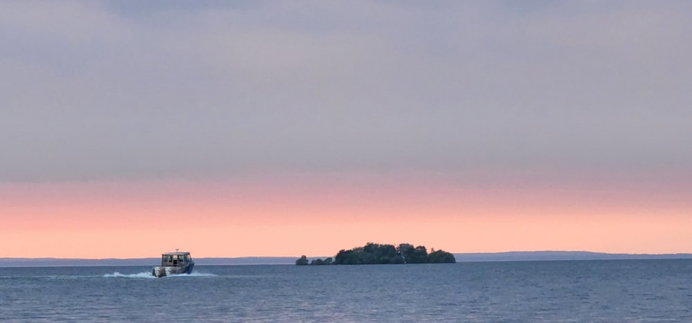 a small boat traveling across a large body of water