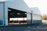 Completed steel hangar with large doors in a rural setting