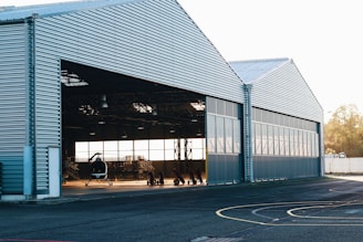 Photo of a bright yellow metal hangar under construction in Abidjan.