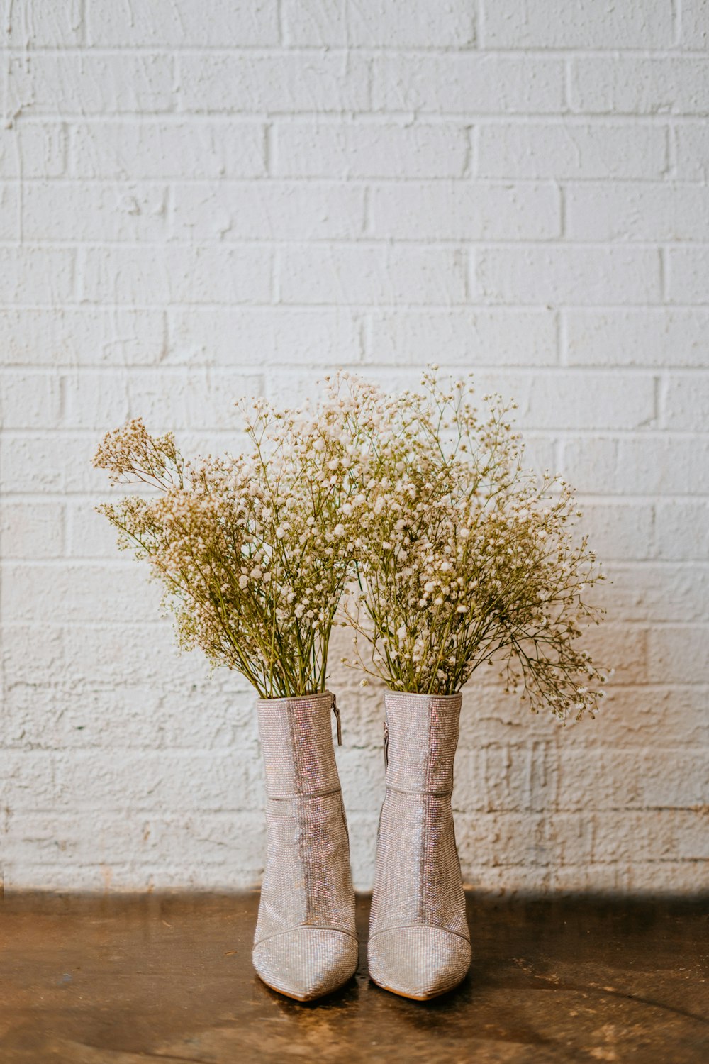 two vases with flowers in them sitting on a table