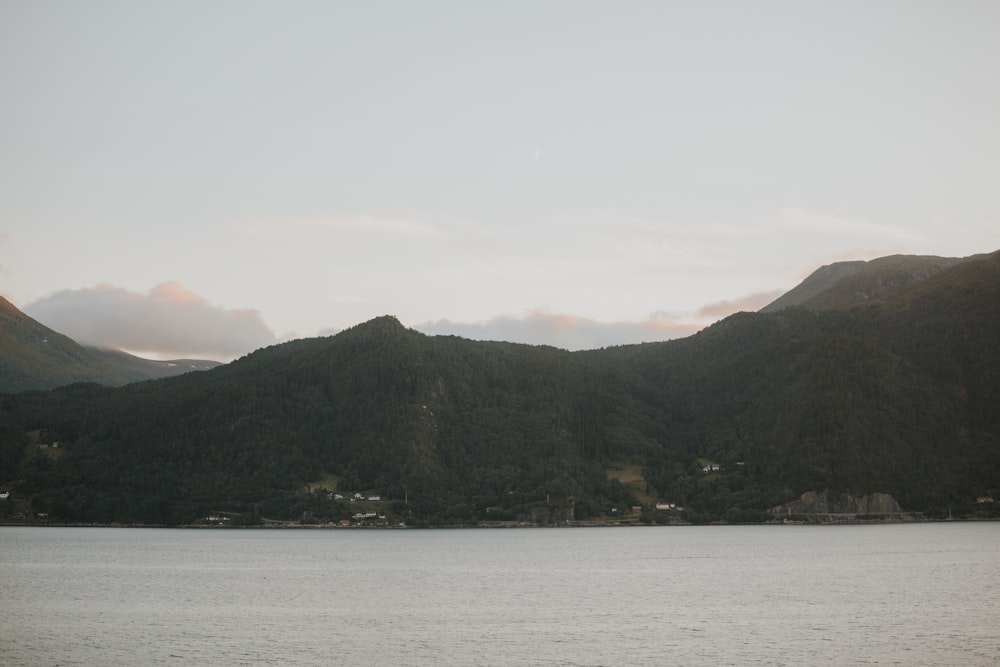 a body of water with mountains in the background