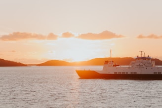 A peaceful ferry gliding over the calm Limfjord waters near Salling peninsula at sunset
