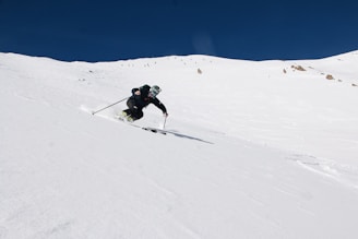 Young skier racing down a snowy slope with determination