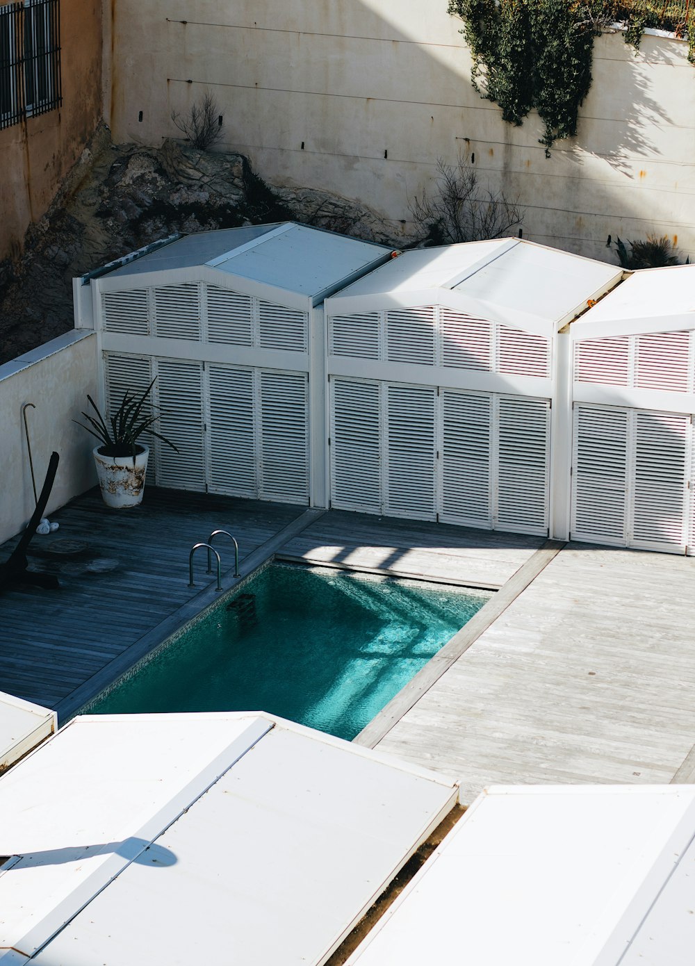 a swimming pool with a white fence surrounding it