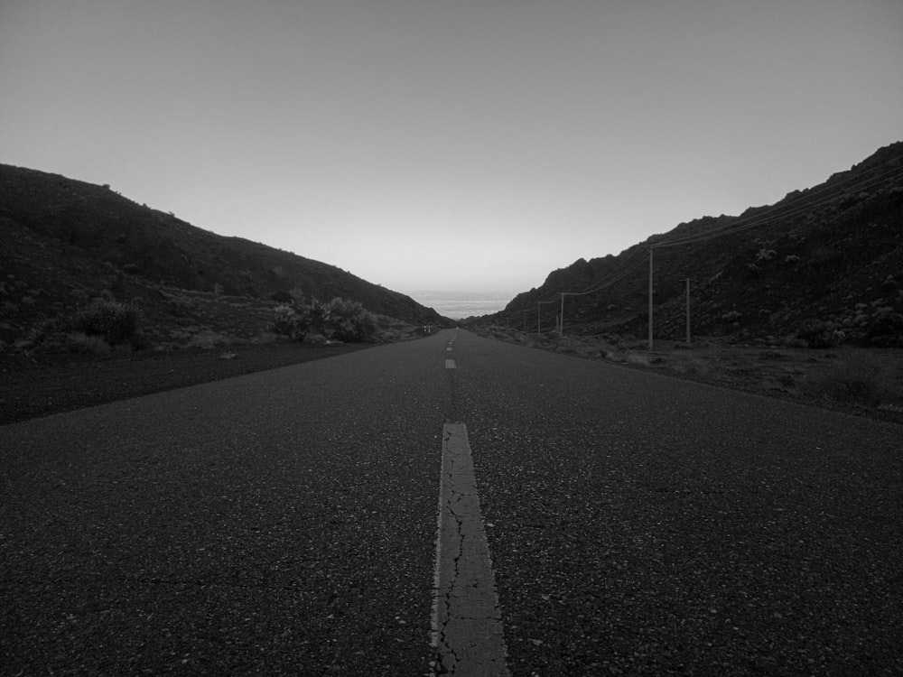 a black and white photo of an empty road