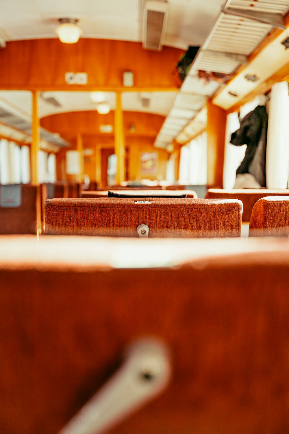 the inside of a train car with wooden seats