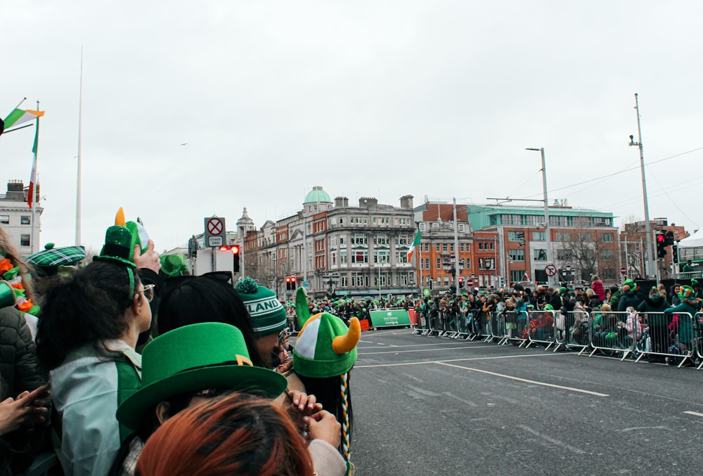 a group of people standing on the side of a road