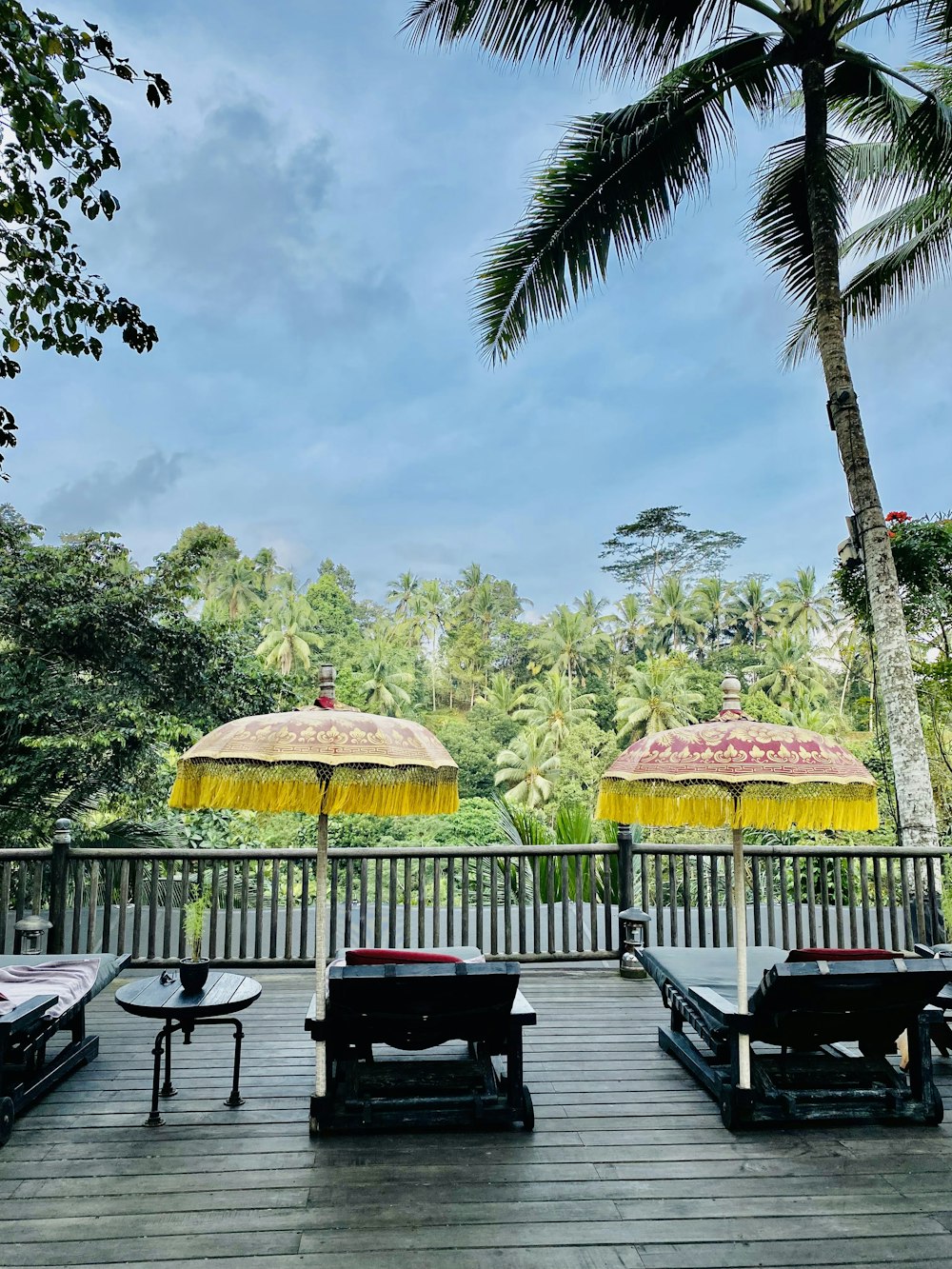 a group of umbrellas sitting on top of a wooden deck