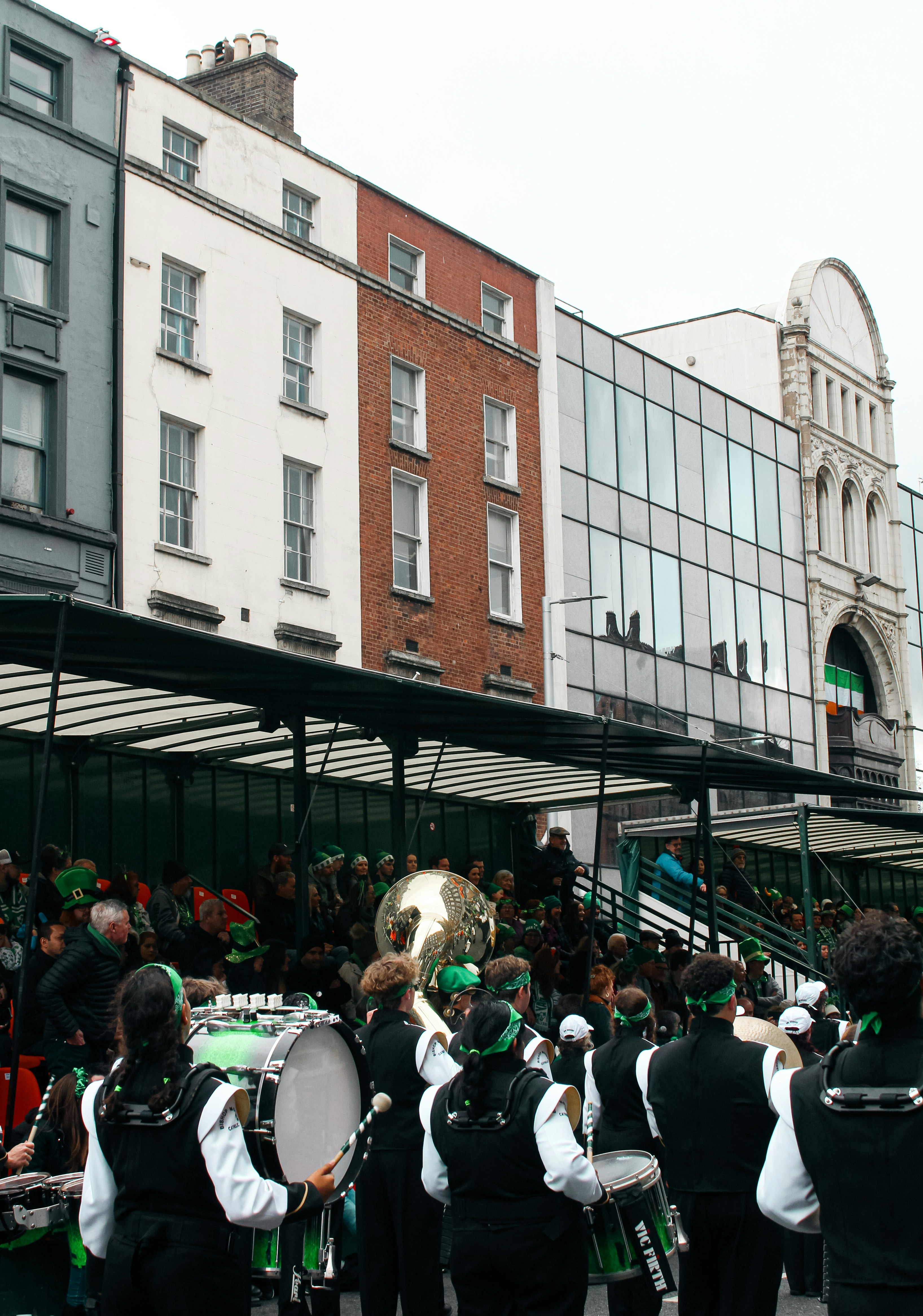 A group of people playing instruments in front of a building