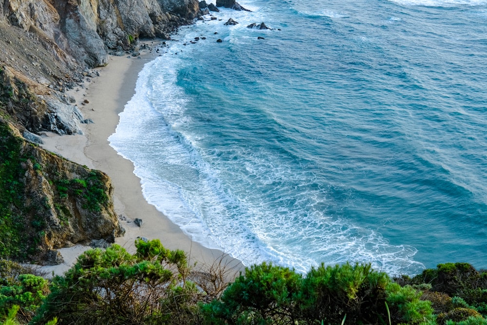 a view of the ocean from the top of a hill