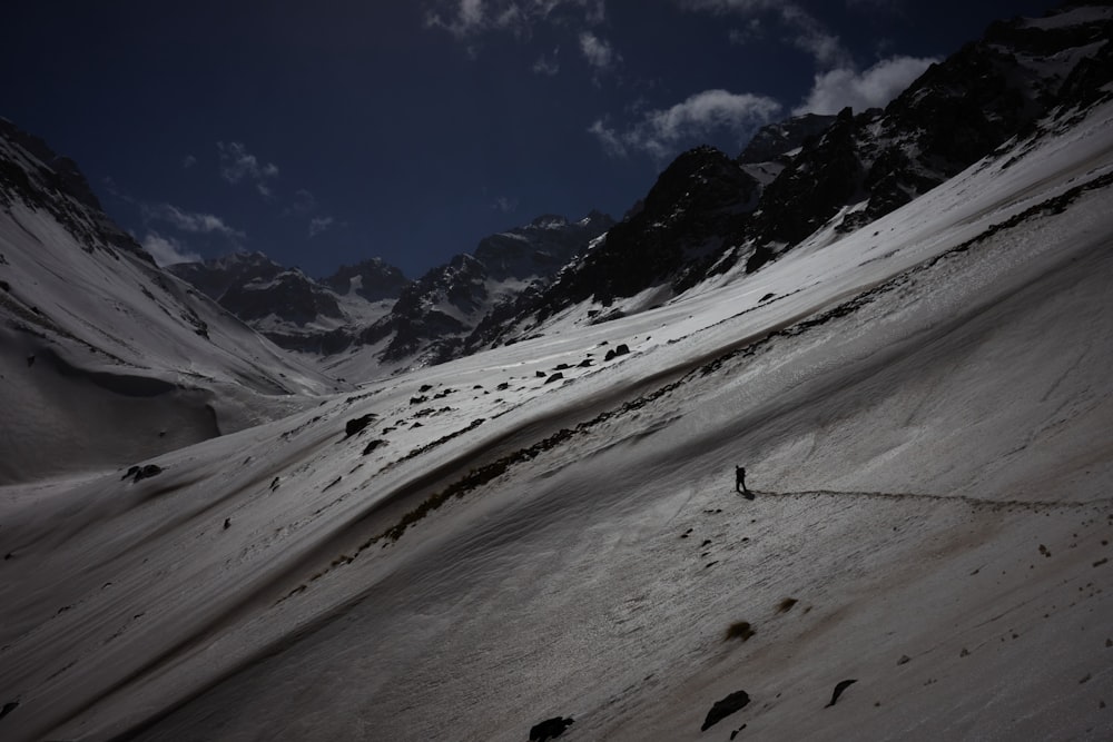 a person hiking up a snow covered mountain