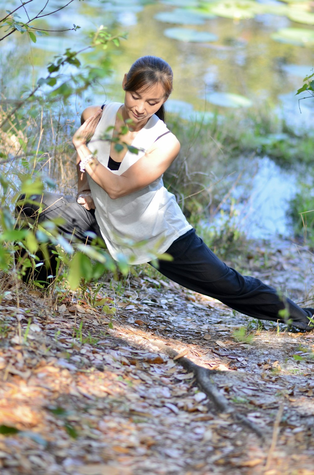 a woman squatting down in the woods