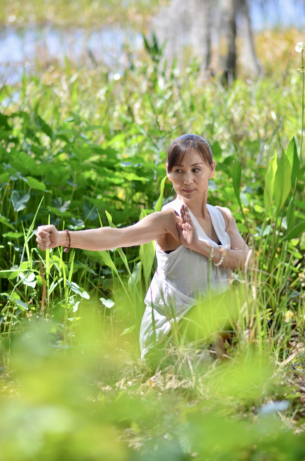 a woman standing in a field of tall grass