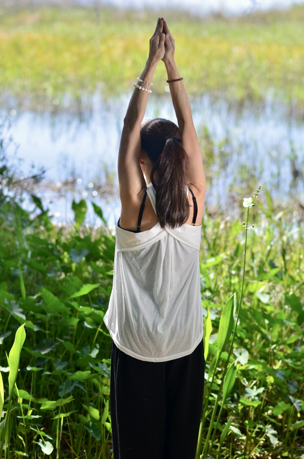 a woman standing in front of a body of water