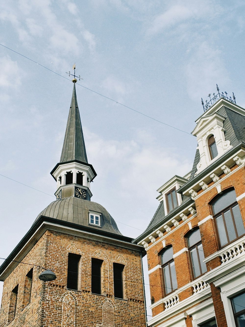 a tall brick building with a clock on the top of it