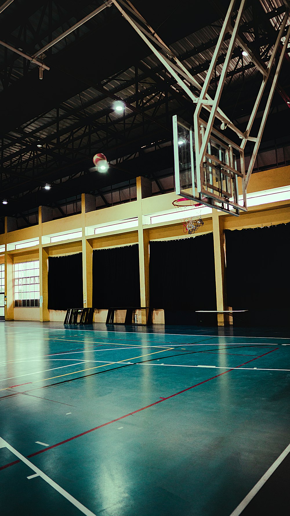 a basketball court with a basketball hoop in the middle of it