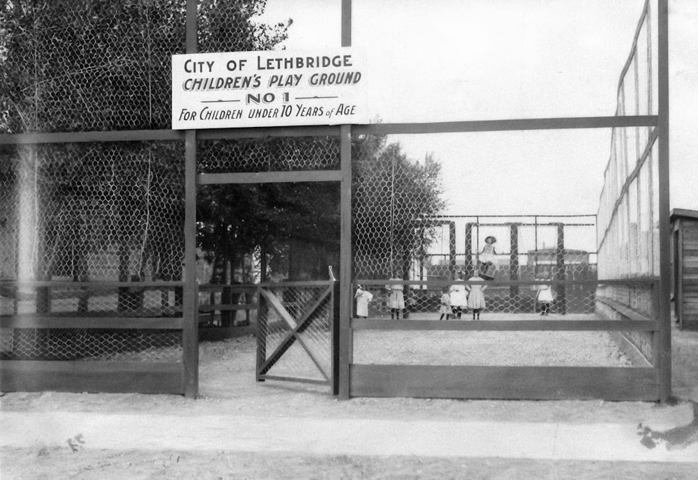 a black and white photo of a fenced in area