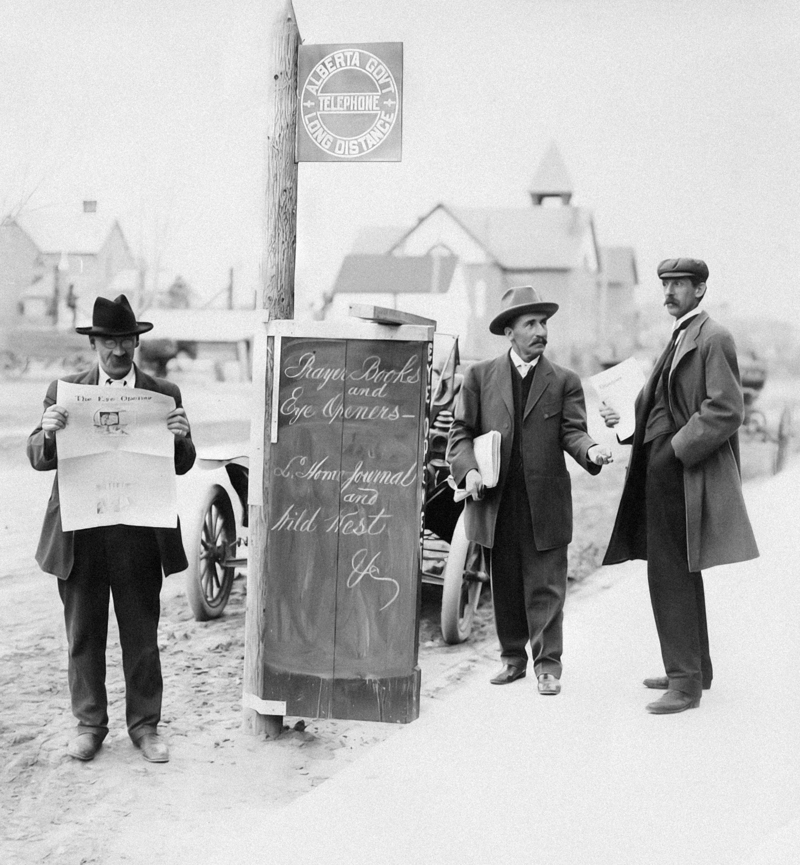 a group of men standing next to a sign