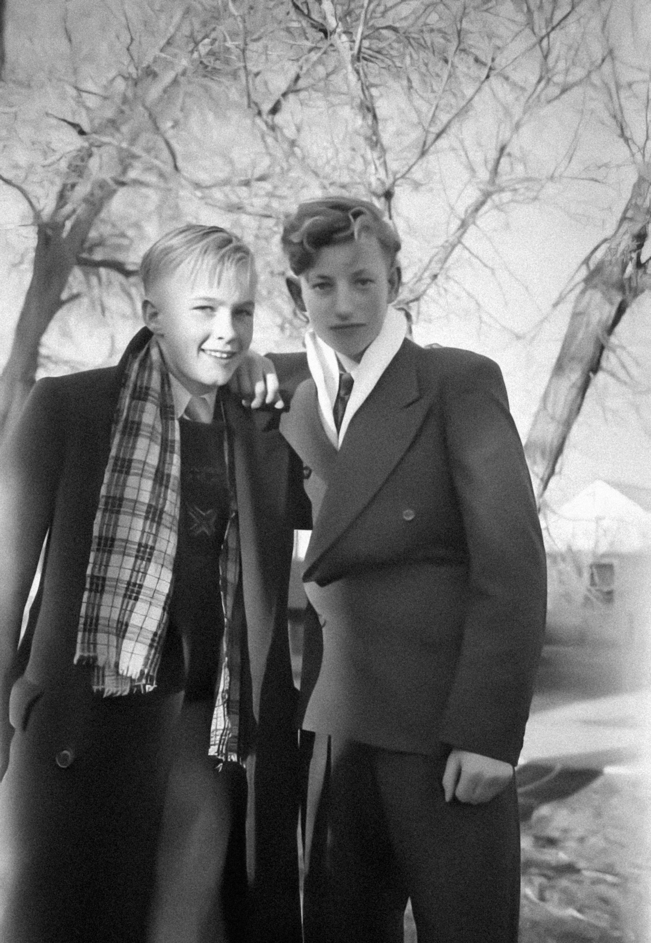 a couple of young men standing next to each other