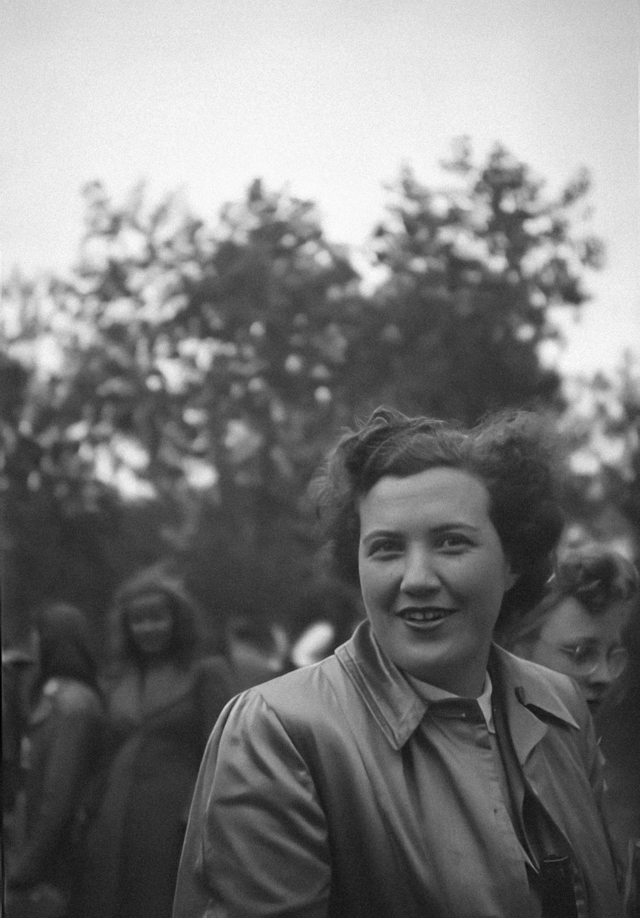 a black and white photo of a woman smiling