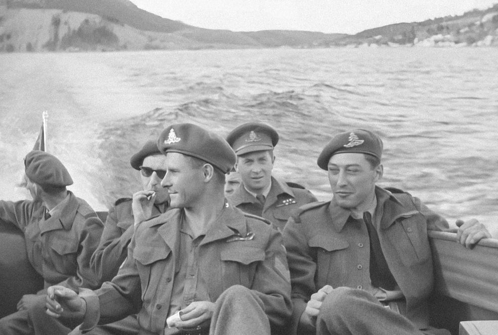 a group of men riding on the back of a boat