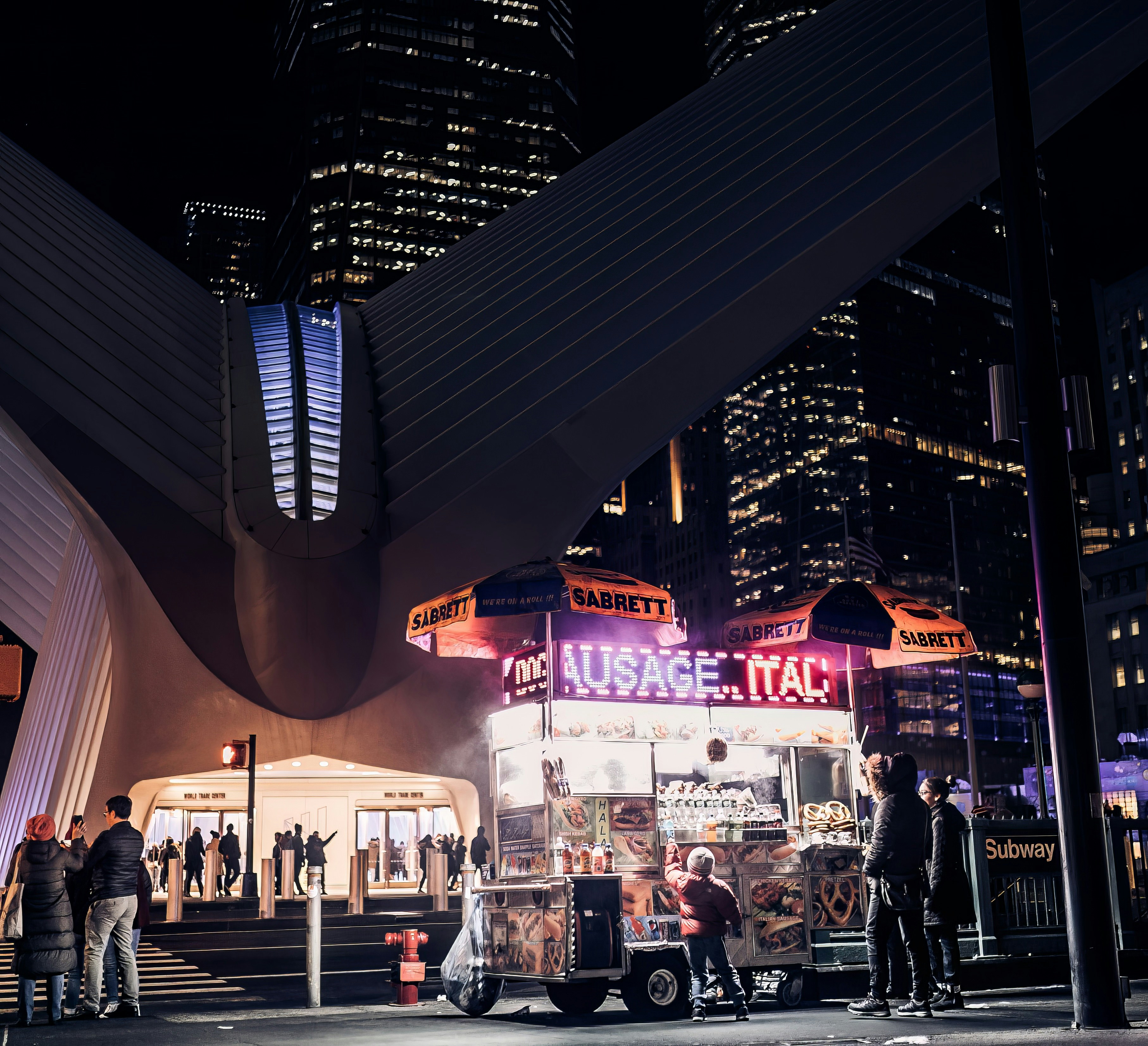 a group of people standing around a food truck