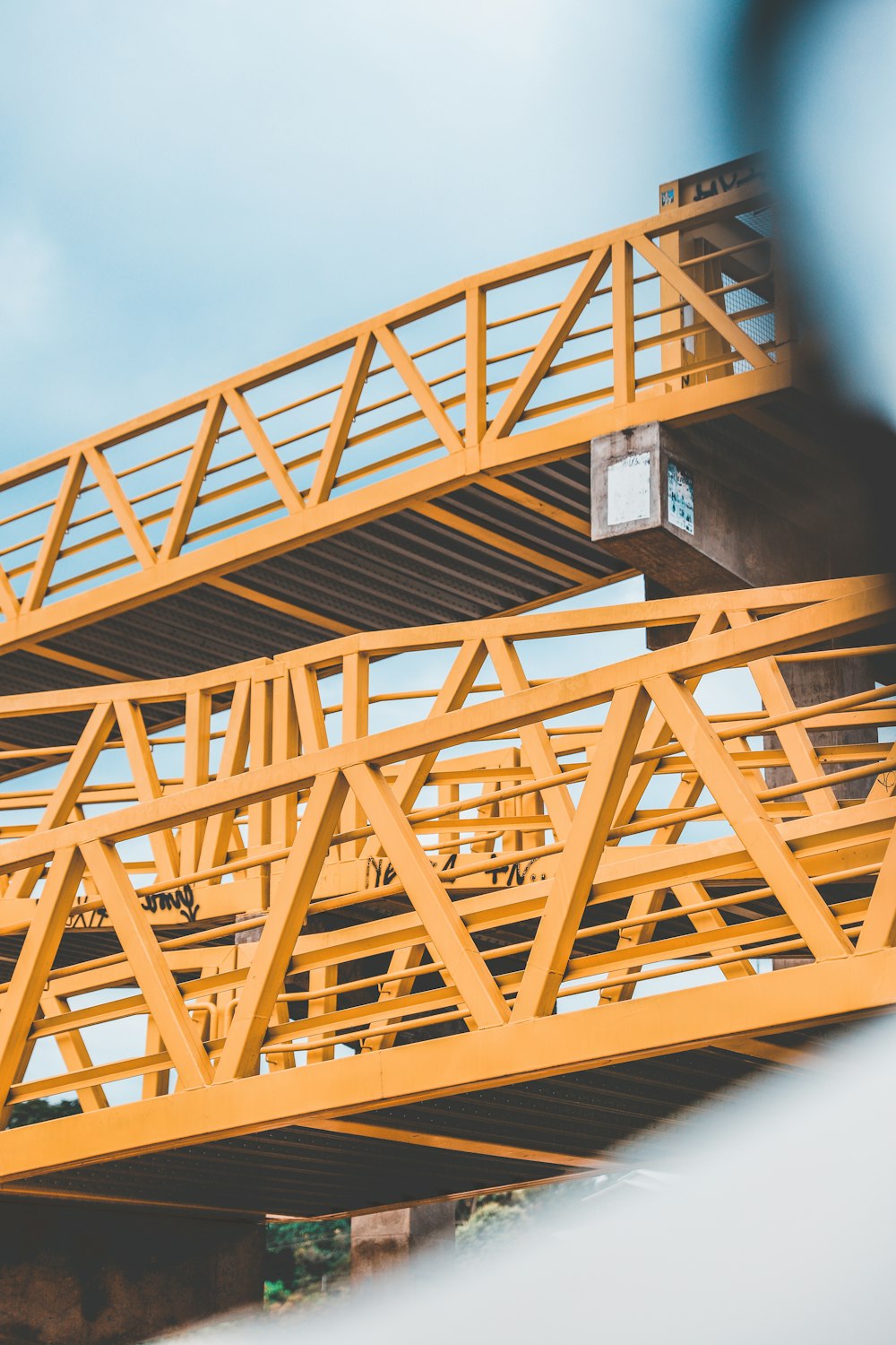 a yellow bridge with a clock on it