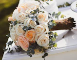 Elegant bouquet of pastel roses and eucalyptus in soft natural light.