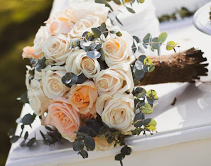 Elegant bouquet of pastel roses and eucalyptus in soft natural light.