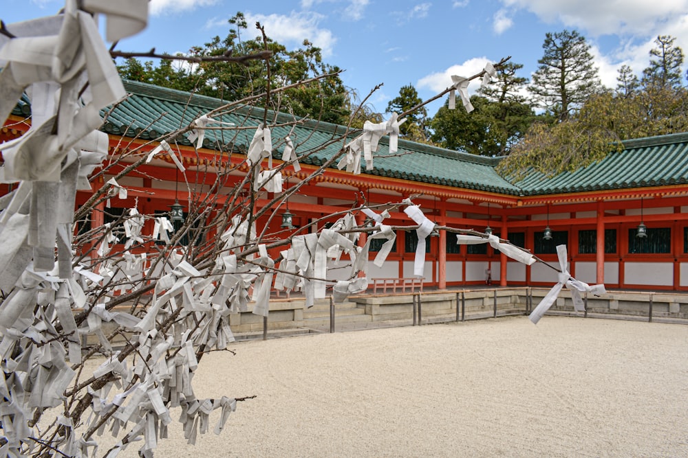 a building with a lot of white paper hanging from it's roof