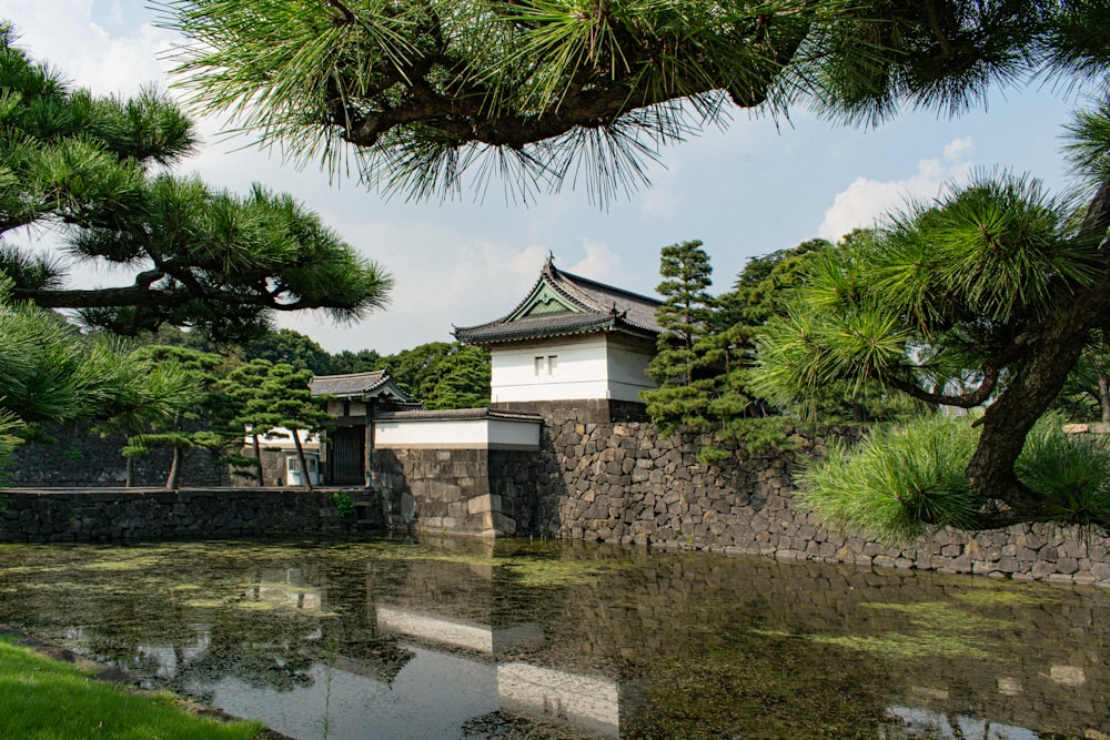 a small building sitting next to a body of water