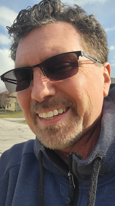 A friendly financial advisor warmly greeting a local family in a small neighborhood setting