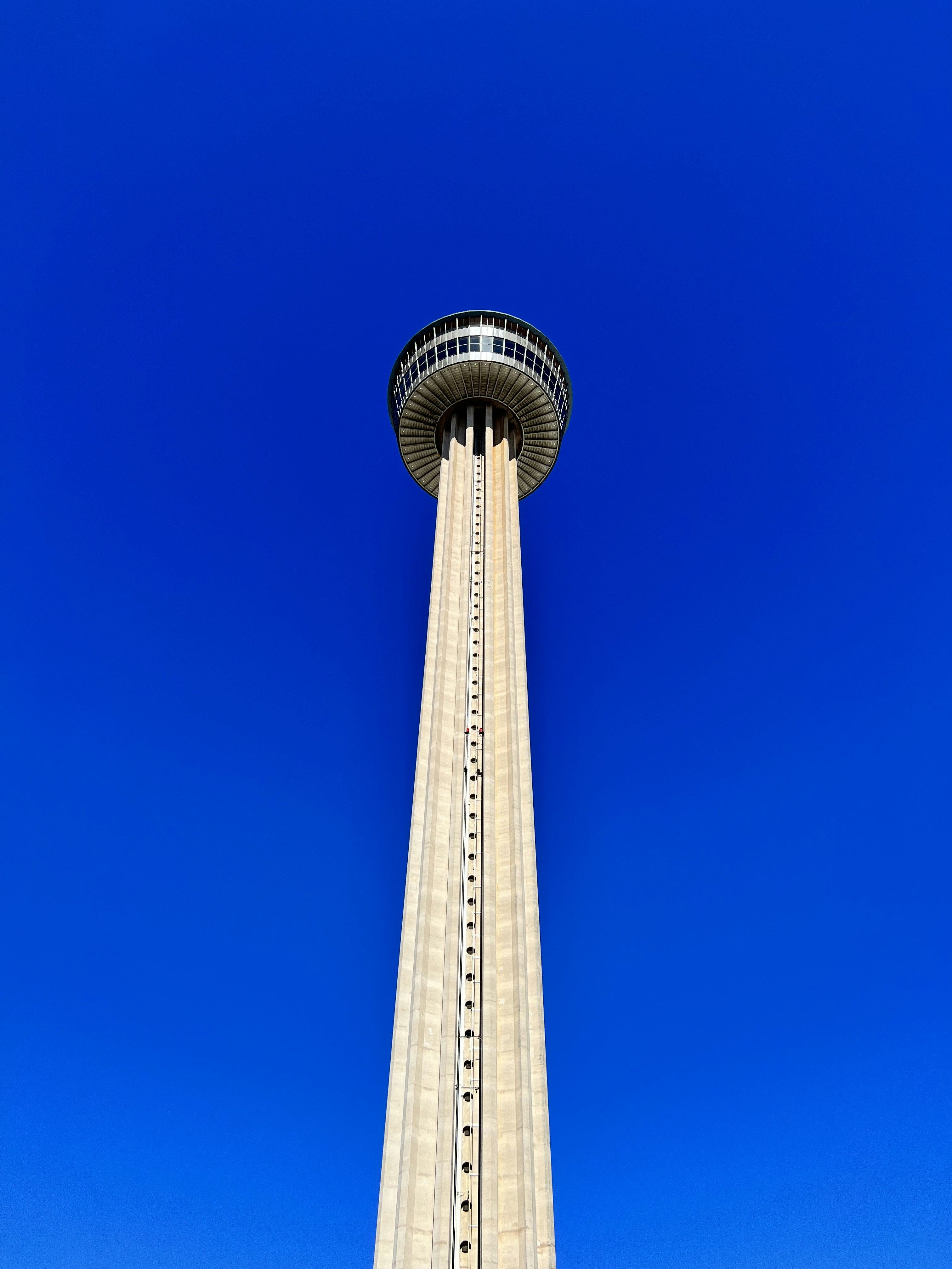 a tall white tower with a blue sky in the background