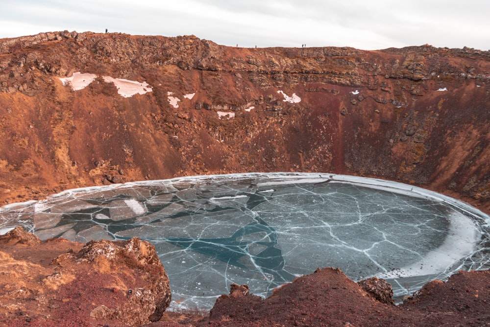 a large crater with ice on the ground
