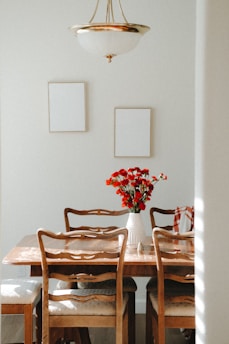 Upholstered linen dining chairs arranged around a rustic wooden table in a cozy dining room.