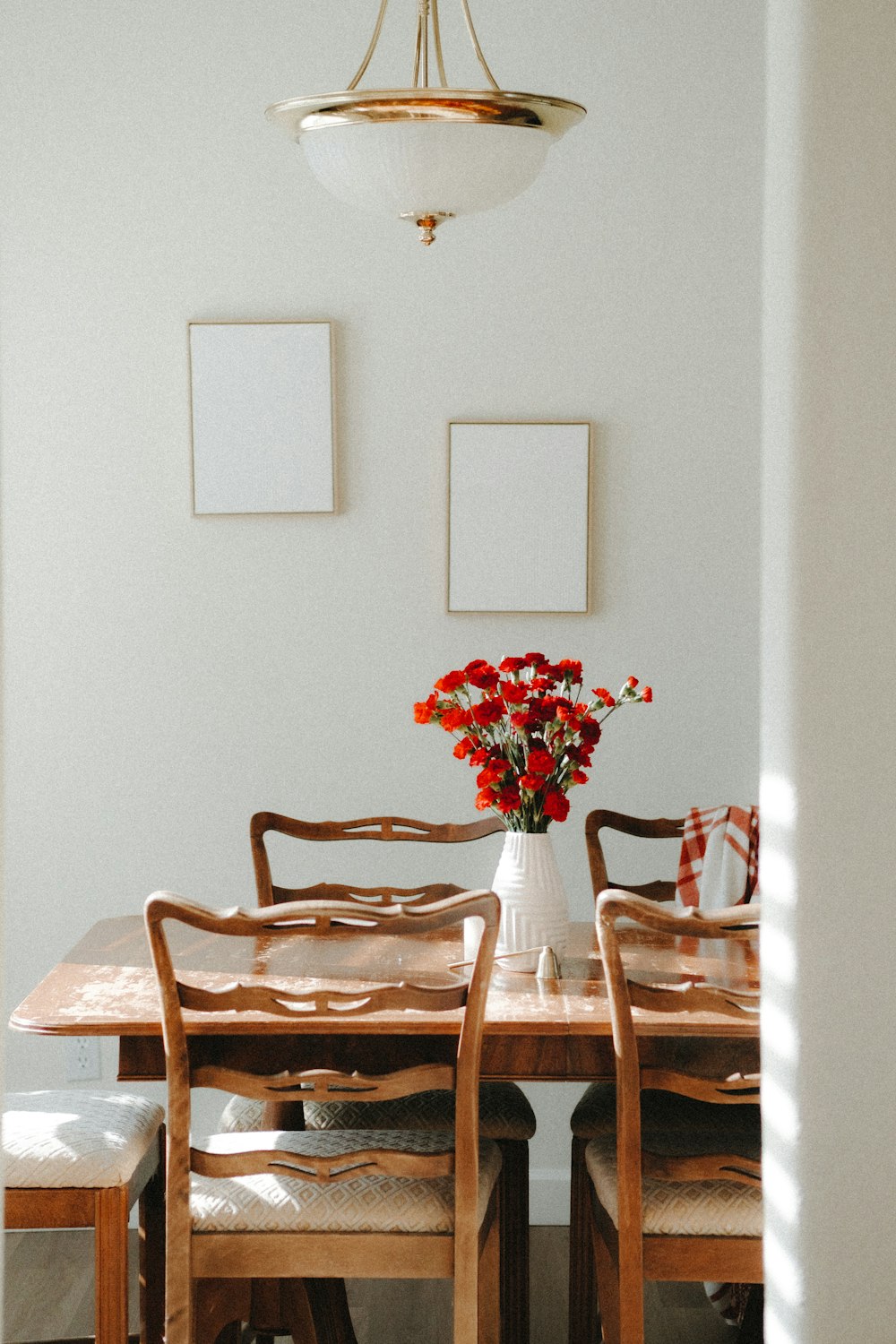 a vase of flowers sitting on top of a wooden table