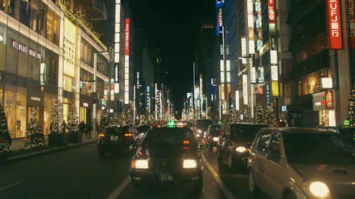 A busy commercial street with multiple businesses glowing from custom LED designs.