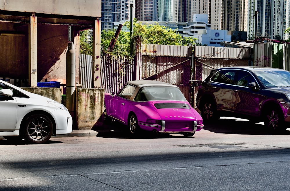 a couple of cars parked next to each other on a street