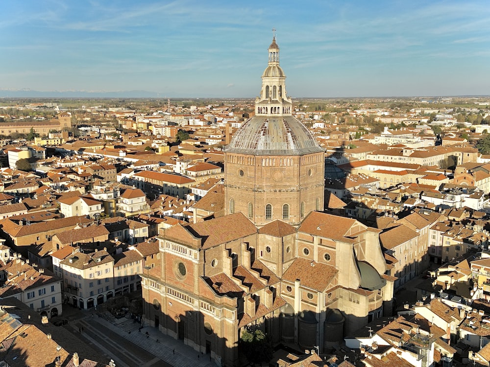 an aerial view of a city with a church tower