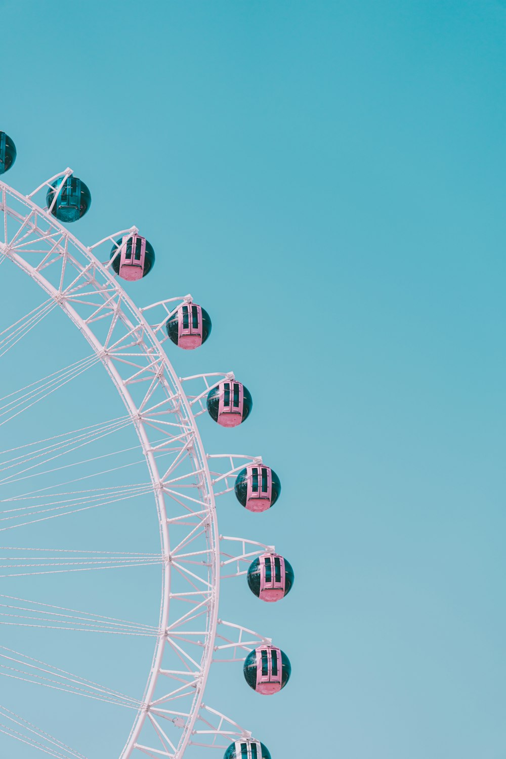 a ferris wheel with pink and black seats