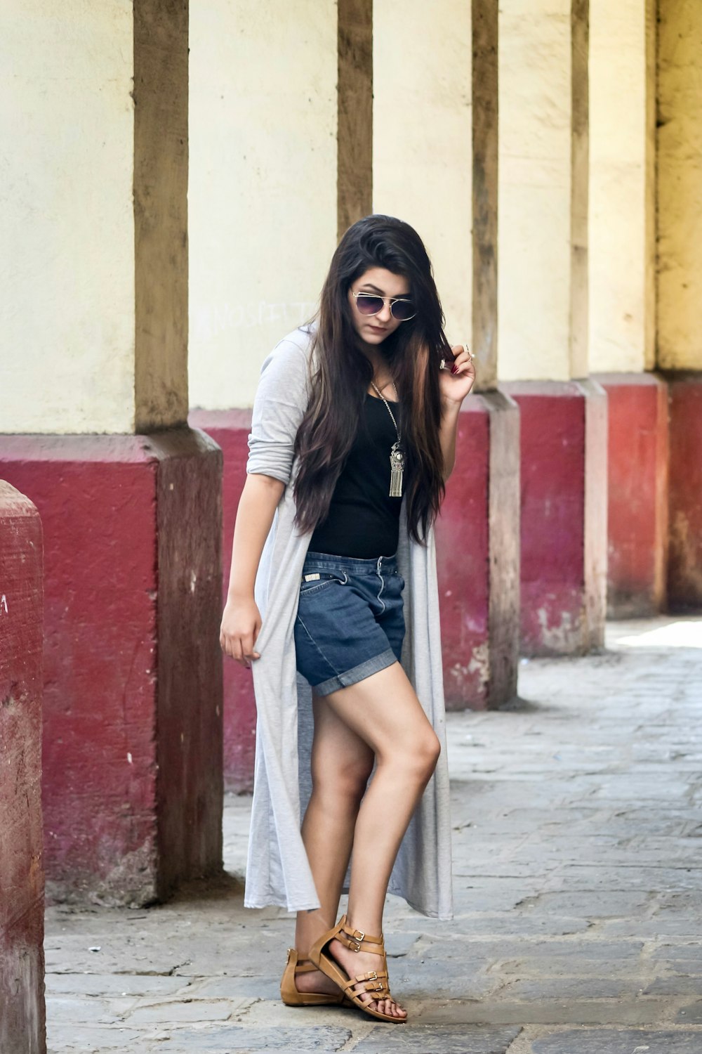 a woman in a black shirt and a white cardigan